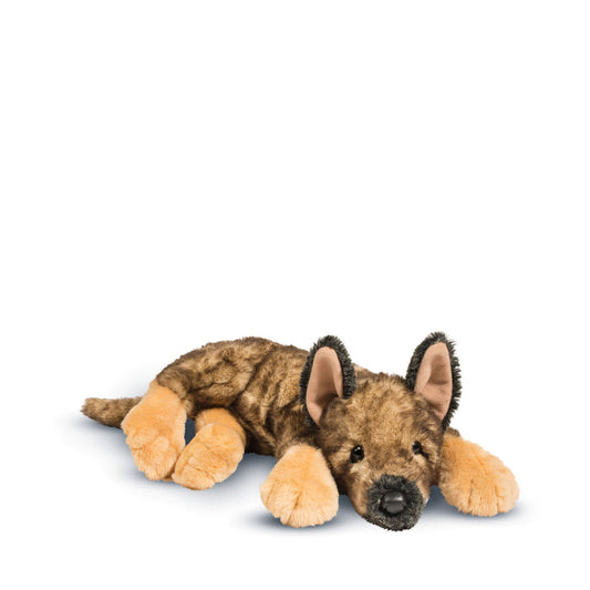 A plush stuffed dog toy lying down on a clean white background. The toy has a brown and black spotted fur pattern on its body, tan paws and legs, and black ears with tan inner linings.