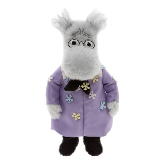 Das ist Minimo Hemul, ein Kuscheltier von Charlie Bears. Das hellgraue Alpakawollfell ist mittellang und zottelig, mit Büscheln an den Ohren; Beine und Füße sind kurz behaart und schwarz. Schnauze und Hände sind hellgrau, Ohreninnenseiten dunkler. Die Augen sind schwarz mit weißem Rand, eingefasst von einer kleinen runden schwarzen Brille; dunkel gestickte Brauen geben ihm einen besorgten Ausdruck. Er steht aufrecht und trägt Kleidung mit floralen Details und eine Krawatte.
